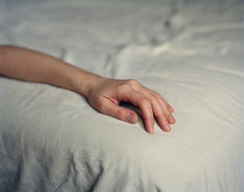 Hand on bed